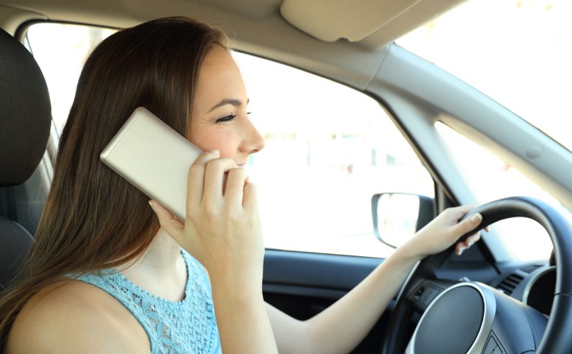 Distracted driver calling on phone driving a car